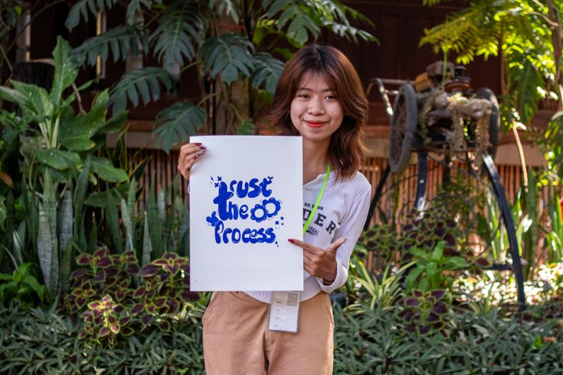 A life skills student at Phare Ponleu Selpak holds up their artwork