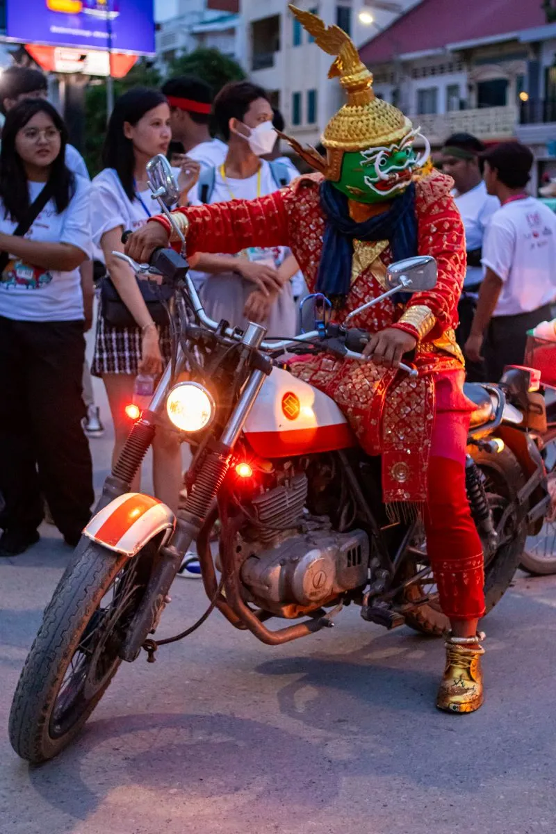 The leader of the art parade on a motorbike in Battambang, Cambodia