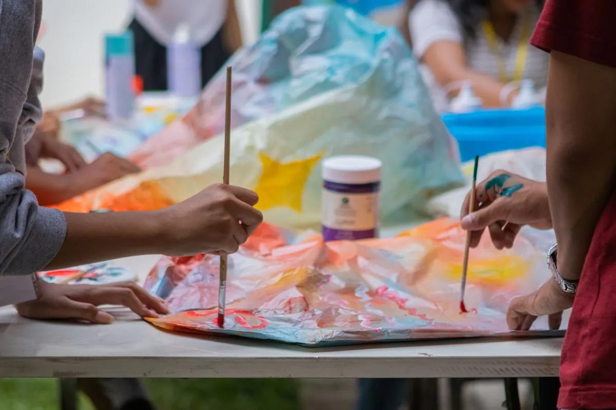 Participants paint lanterns during an art workshop at Phare Ponleu Selpak