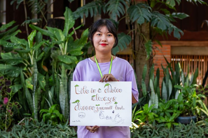 A life skills student at Phare Ponleu Selpak holds up their artwork