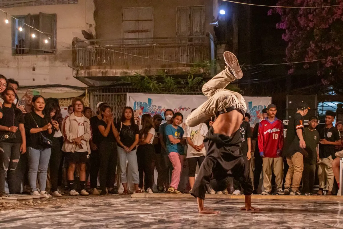 A breakdancer stands on his hands during "Art After Dark" during the S'Art Urban Arts Festival