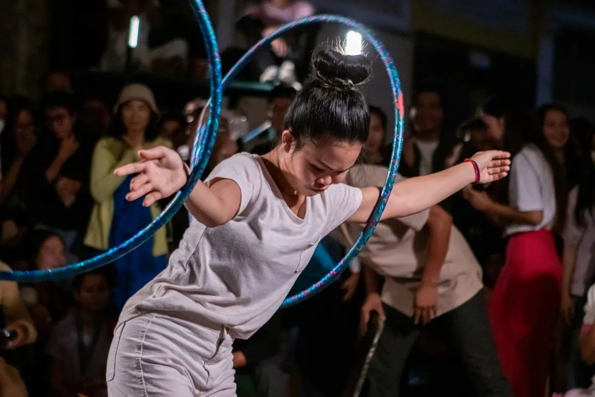 A circus performer wields two hula-hoops during the S'Art festival in Battambang