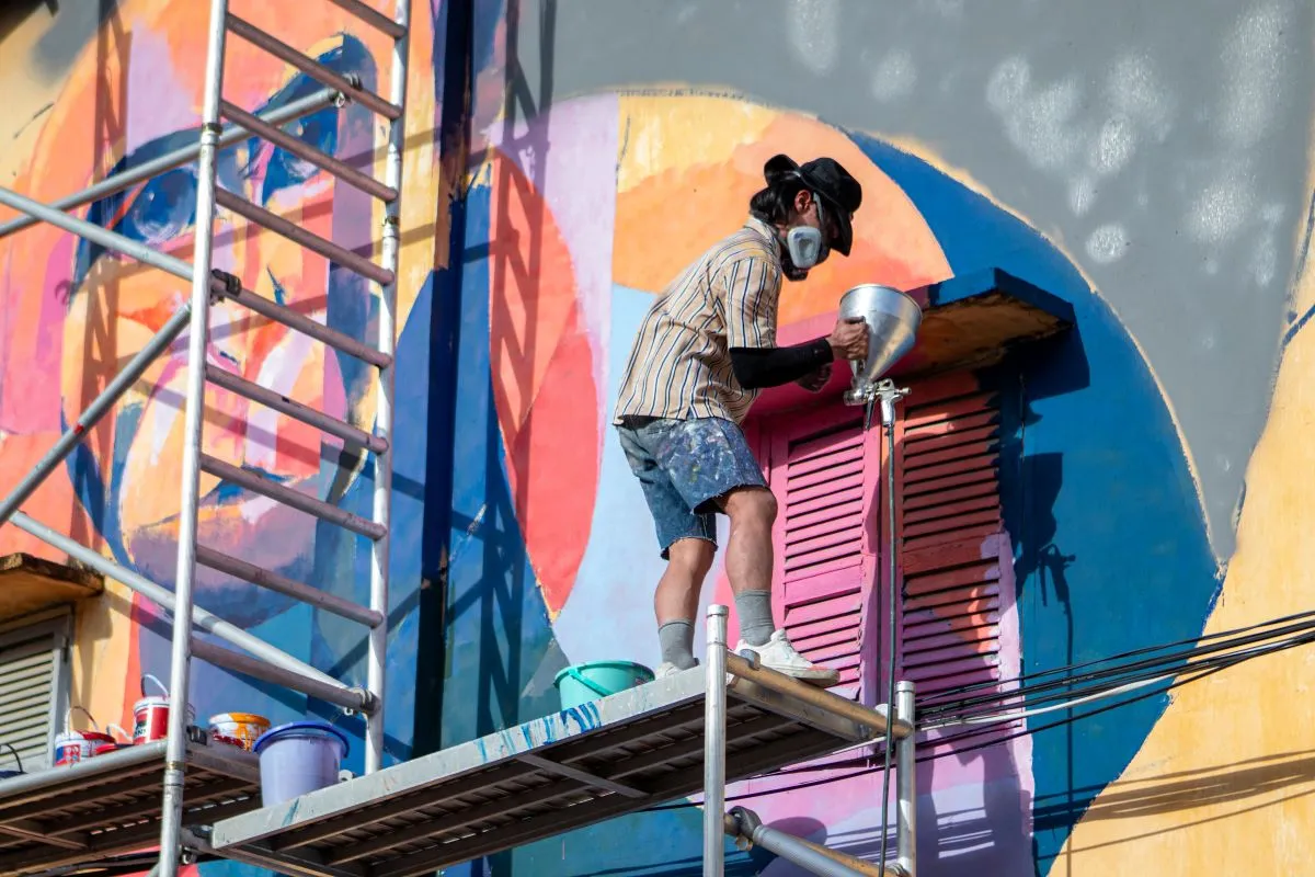 A mural artist paints in Battambang, Cambodia