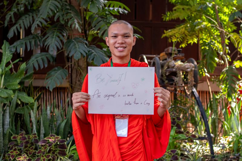 A life skills student at Phare Ponleu Selpak holds up their artwork