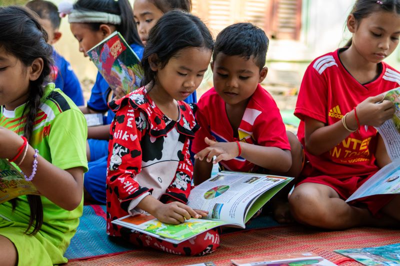 Children read books in Battambang.