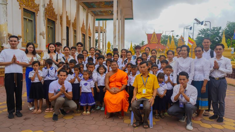 students and teachers with a monk at the pagoda Pchum Ben