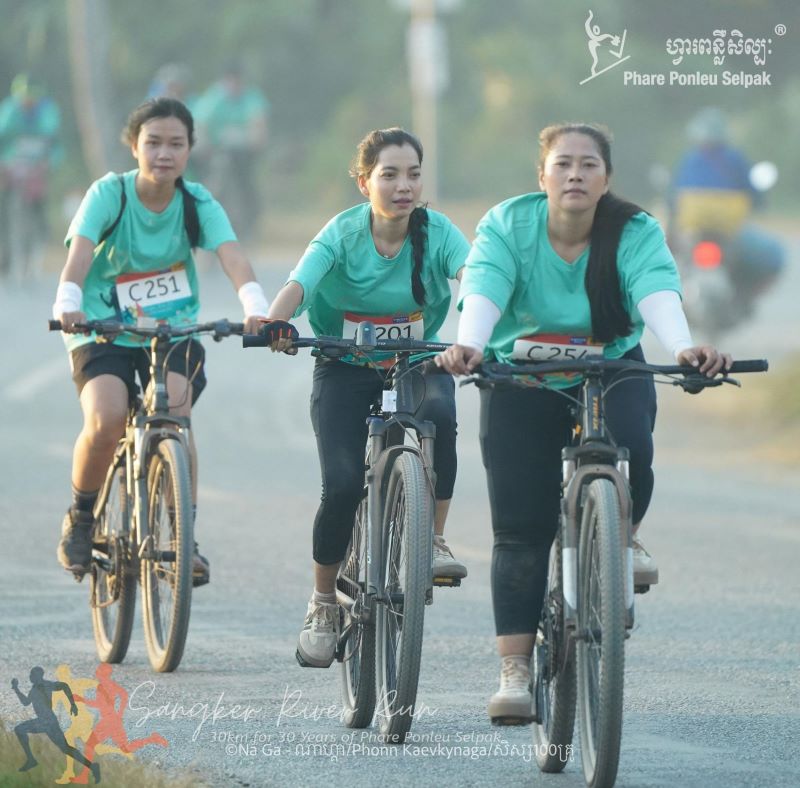 Three cyclists participating in the Sangker River Run in Battambang, Cambodia