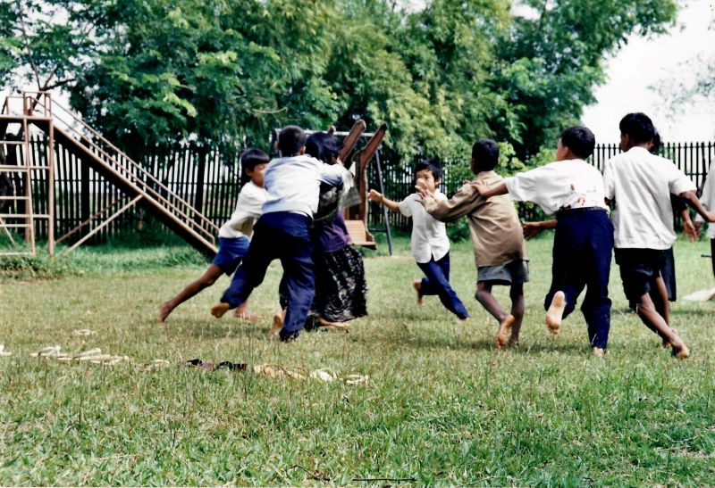 Children playing field games in Battambang, Cambodia